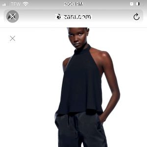 Halter top with open back. Back button closure.
Black .